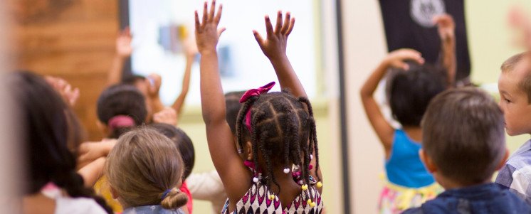 Children with their hands in the air