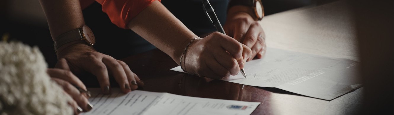 People signing a form
