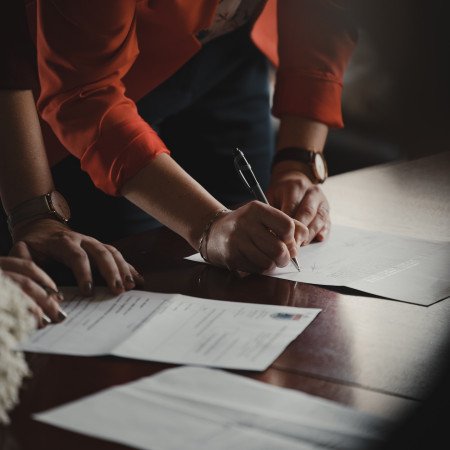 People signing a form